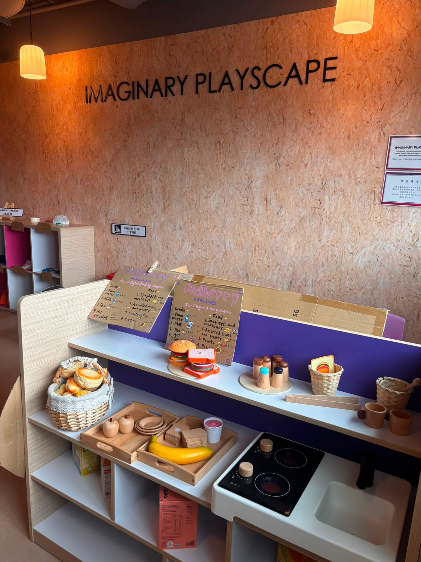 A dramatic play area styled as a market and airport check-in