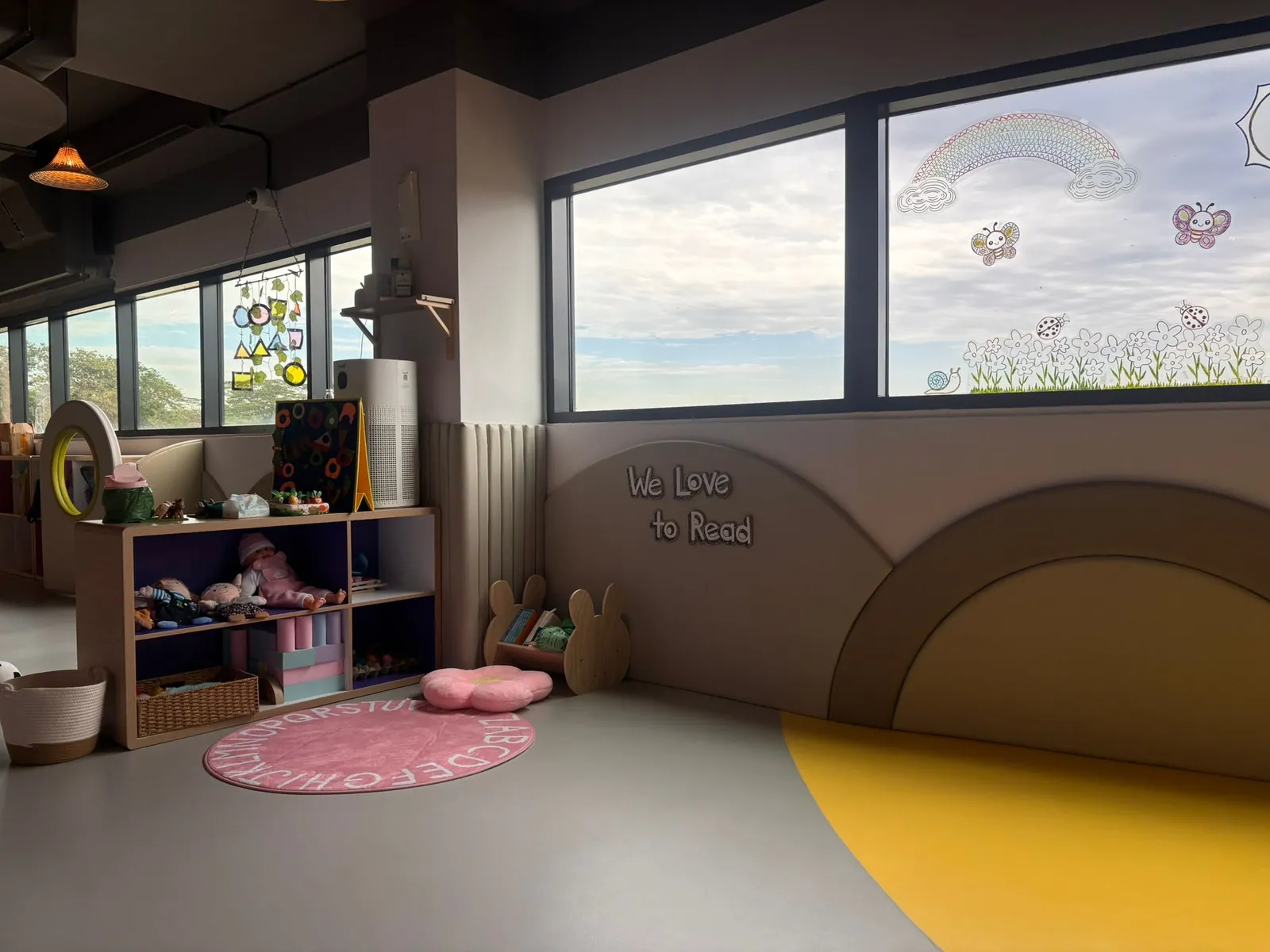 The reading corner with its We Love to Read wall, doll shelf and alphabet rug