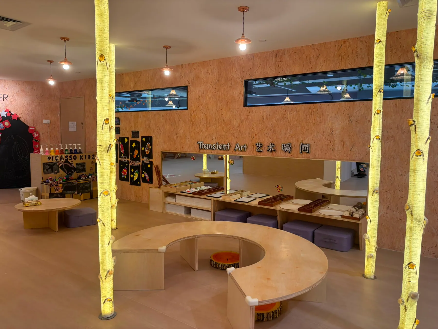 A light-filled art studio with glowing birch-tree columns